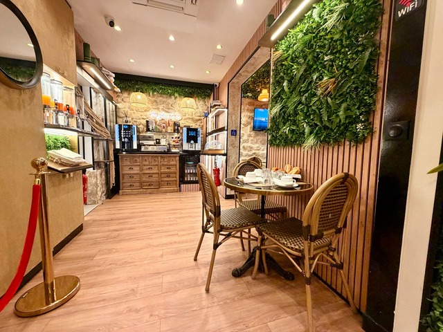 The tables in the breakfast room with the buffet in the background