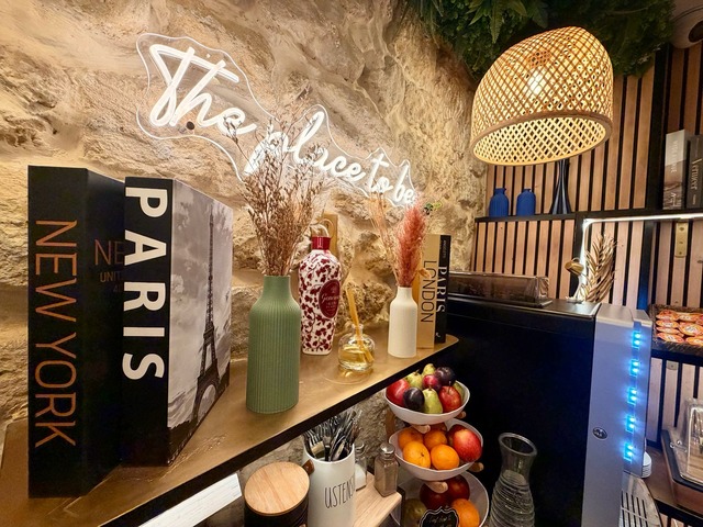 The buffet corner: fruit bowl, decorative books and illuminated sign
