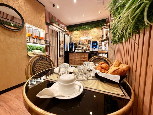 A set table with croissants, the buffet in the background